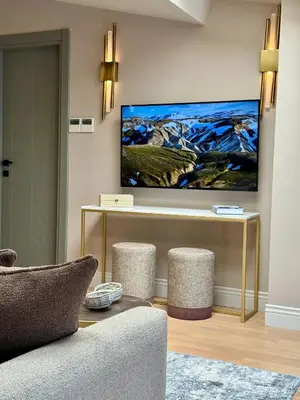 a living room with a tv on a wall at Weingart Suites Hotel in Istanbul