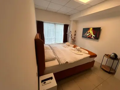 a bedroom with a bed in a room with a window at Kadıköy Bull Hotel in Istanbul