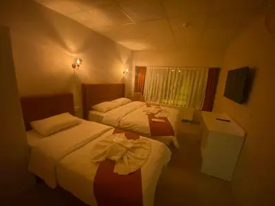 a hotel room with two beds and a window at Kadıköy Bull Hotel in Istanbul