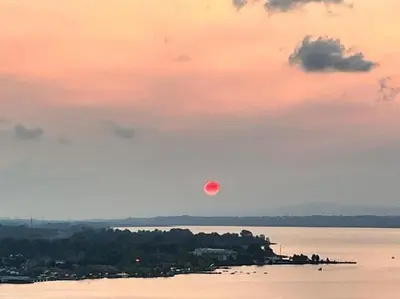 a red moon in the sky over a body of water at White Home Sapanca in Sapanca