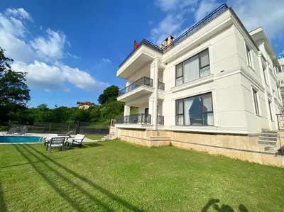 a large white house with a yard and a pool at White Home Sapanca in Sapanca