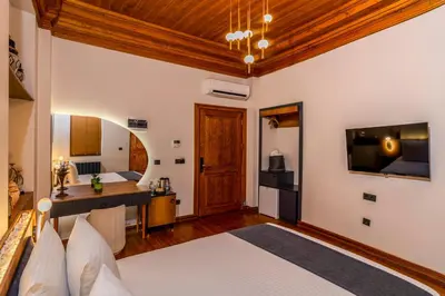 a bedroom with a bed and a desk in a room at Elmira Pera Hotel & - Special Class in Istanbul