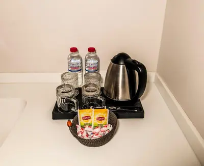 a tray with bottles of water and a tea kettle at Elmira Pera Hotel & - Special Class in Istanbul
