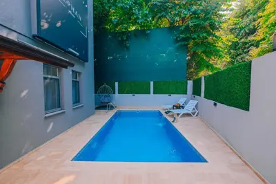 a swimming pool in a house with a large painting on the wall at Alphan House in Sapanca