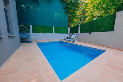 a swimming pool in the middle of a house at Alphan House in Sapanca