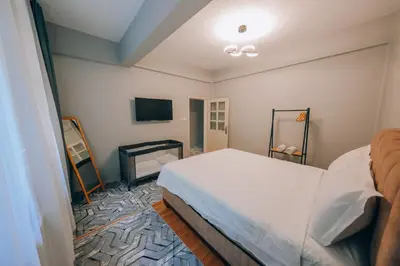 a bedroom with a bed and a flat screen tv at Alphan House in Sapanca
