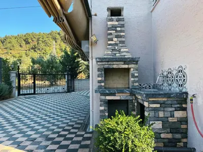a stone fireplace on the side of a building at Doğanın Kalbindeki Eviniz-7 Kişi in Gemlik