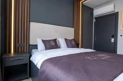 a bedroom with a large bed with a large mirror at FLY POINT AIRPORT HOTEL in Arnavutköy