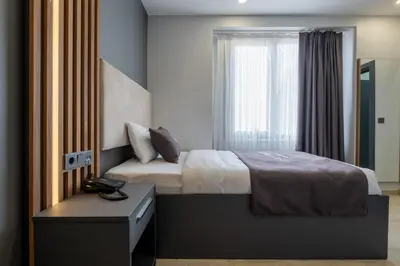 a bedroom with a bed and a window at FLY POINT AIRPORT HOTEL in Arnavutköy