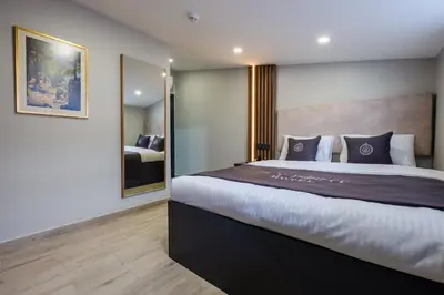 a bedroom with a large bed and a mirror at FLY POINT AIRPORT HOTEL in Arnavutköy