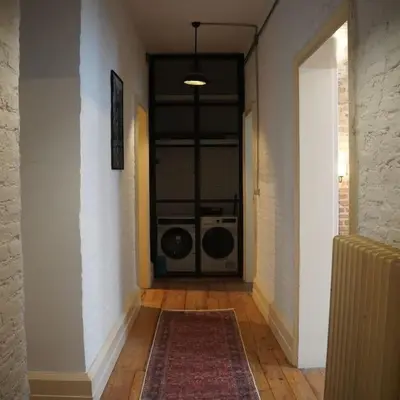 a hallway with a door with a washing machine in it at GALATA KULESİ yakınında geniş 3+1 tarihi daire in Istanbul