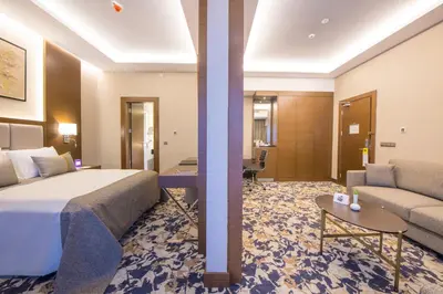 a hotel room with a bed and a couch at Crowne Plaza Yalova by IHG in Yalova