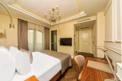 a hotel room with a bed and a tv at Hotel Morione & Spa Center in Istanbul
