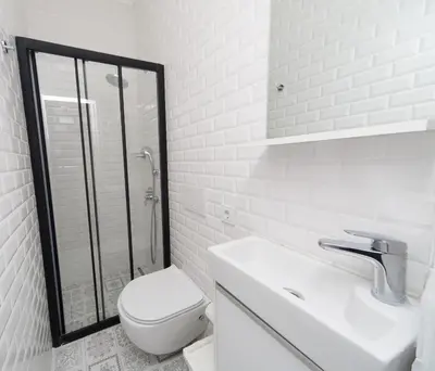 a white bathroom with a toilet and a shower at Cenar Konak Butik Hotel in Buyukada