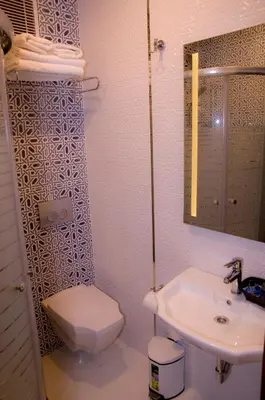 a bathroom with a white toilet and a sink at Kerimbey Hotel in Gemlik