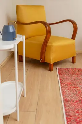 a yellow chair sitting next to a white table at Havyar Apartment in Istanbul