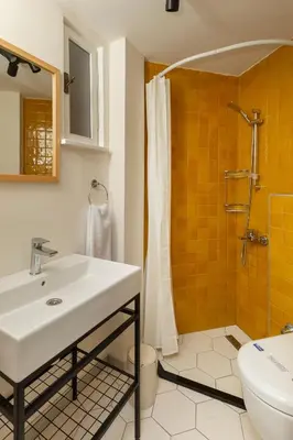 a bathroom with a sink and a shower and a toilet at Havyar Apartment in Istanbul