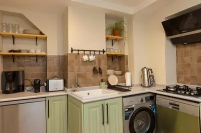 a kitchen with a sink and a washing machine at Havyar Apartment in Istanbul