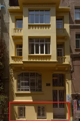 a yellow building with a red line in front of it at Havyar Apartment in Istanbul
