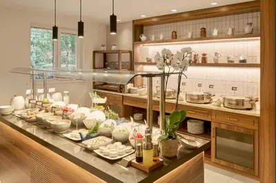 a kitchen with a buffet of food on a counter at The Marmara Camlica in Istanbul