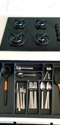 a stove top with utensils in a black tray at فلل التن تاج ALTINTAC villalari in Sapanca