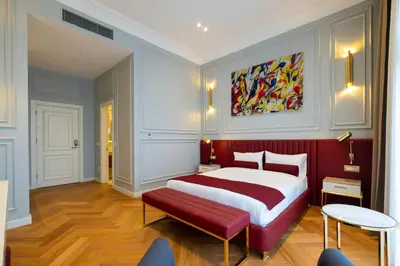 a bedroom with a large bed and a red bench at New Inn Hotel Old Town in Istanbul