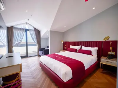 a bedroom with a large bed with a red headboard at New Inn Hotel Old Town in Istanbul