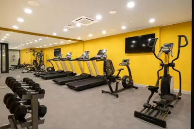a gym with a row of treadms and cardio machines at New Inn Hotel Old Town in Istanbul
