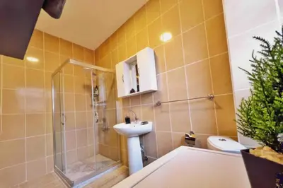 a bathroom with a sink and a shower and a toilet at Cihangir House in Istanbul