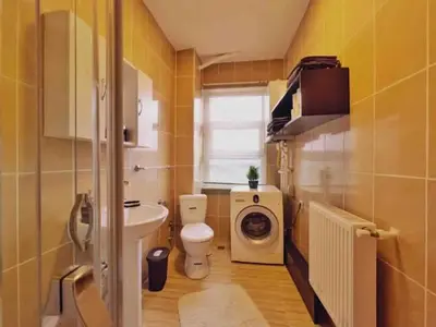 a bathroom with a toilet and a washing machine at Cihangir House in Istanbul