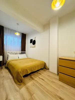 a bedroom with a bed and a dresser in it at Дуплекс с видом на Босфор in Istanbul