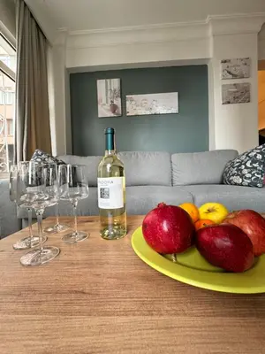 a bottle of wine and a plate of fruit on a table at Дуплекс с видом на Босфор in Istanbul