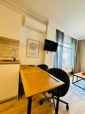 a living room with a wooden table and chairs at Дуплекс с видом на Босфор in Istanbul