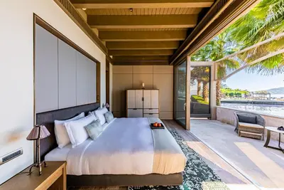 a bedroom with a large bed and a patio at Princes' Palace Resort, Buyukada - Member of The Leading Hotels of the World in Adalar