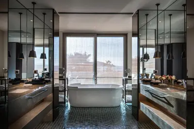 a bathroom with a tub and two sinks at Princes' Palace Resort, Buyukada - Member of The Leading Hotels of the World in Adalar