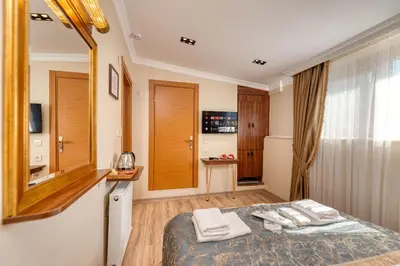 a bedroom with a bed with towels on it at Brown 2 Mansion Oldcity in Istanbul