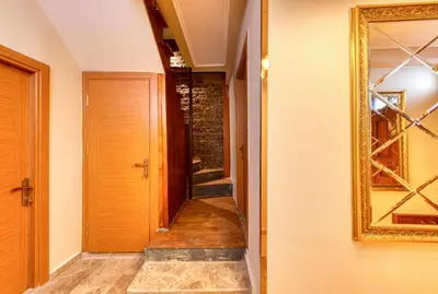 a hallway with a door and a mirror on the wall at Brown 2 Mansion Oldcity in Istanbul