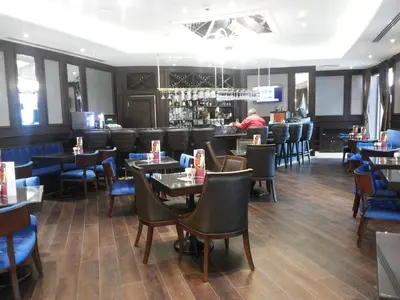 a restaurant with tables and chairs and a bar at Crowne Plaza Istanbul Oryapark by IHG in Istanbul