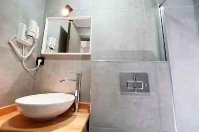 a bathroom with a white sink and a shower at Meet İstanbul Hotel Kadikoy in Istanbul