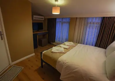 a bedroom with a bed with two towels on it at THE BEYBÛN HOTEL İstiklal Street Taksim in Istanbul