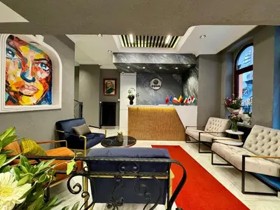 a living room filled with furniture and a painting at THE BEYBÛN HOTEL İstiklal Street Taksim in Istanbul