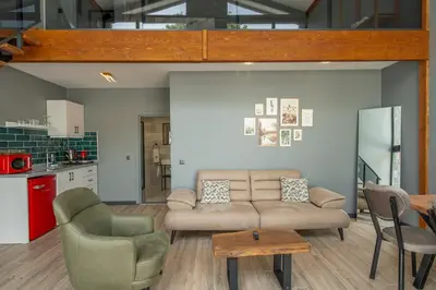 a living room with a couch and two chairs at Sapanca Kokina Suit in Sakarya