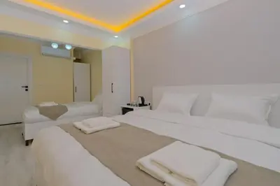 a bedroom with two beds with towels on them at Lucky Hotel İstanbul in Istanbul