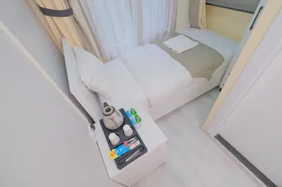 a small bed in a small room with a side table at Lucky Hotel İstanbul in Istanbul