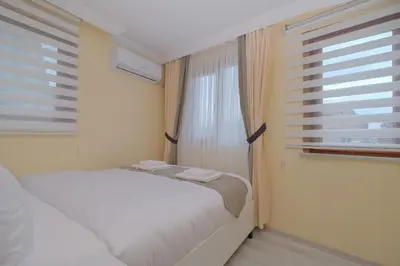 a small bedroom with a bed and a window at Lucky Hotel İstanbul in Istanbul