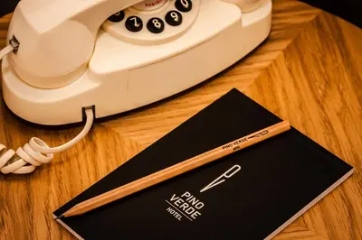 a telephone and a card on a wooden table at Pino Verde Hotel in Istanbul