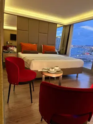 a hotel room with a bed and a table and chairs at Manesol Old City Bosphorus in Istanbul