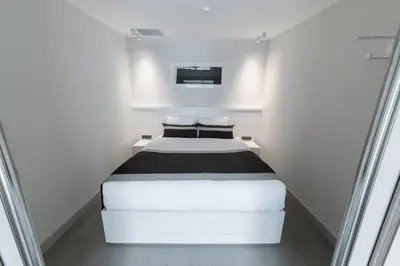 a small white room with a bed in it at The Public Ortakoy in Istanbul