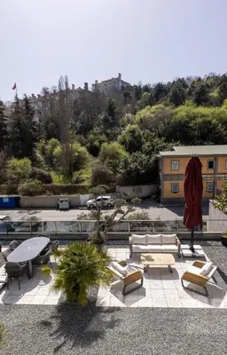 a patio with couches and tables and a building at The Public Ortakoy in Istanbul