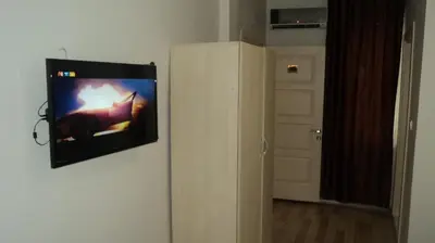 a television hanging on a wall in a room at Kadikoy Bade 3 Hotel in Istanbul